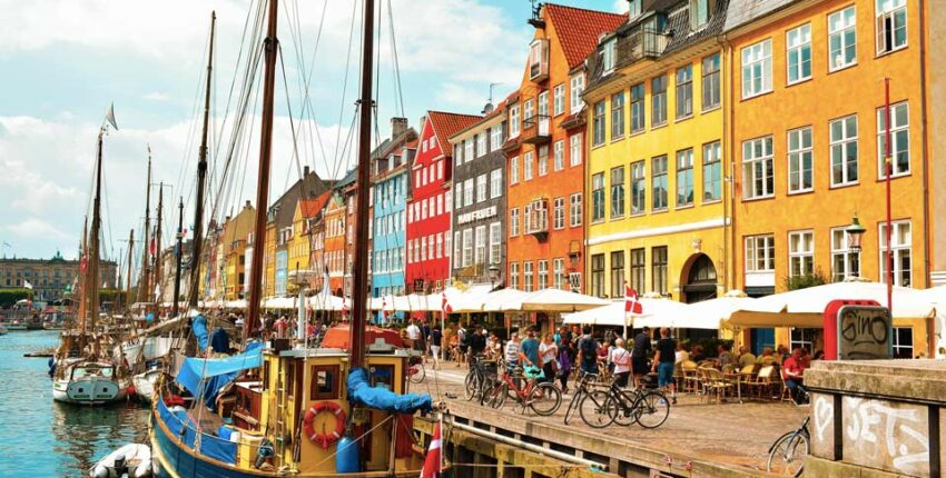 Canal de Nyhavn à Copenhague, bâtiments colorés et cafés.