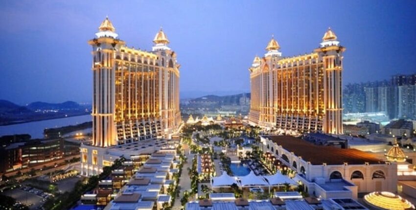 Grand hôtel et casino avec tours jumelles illuminées.